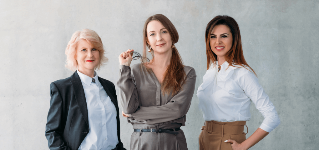 female real estate agents pose in their professional attire